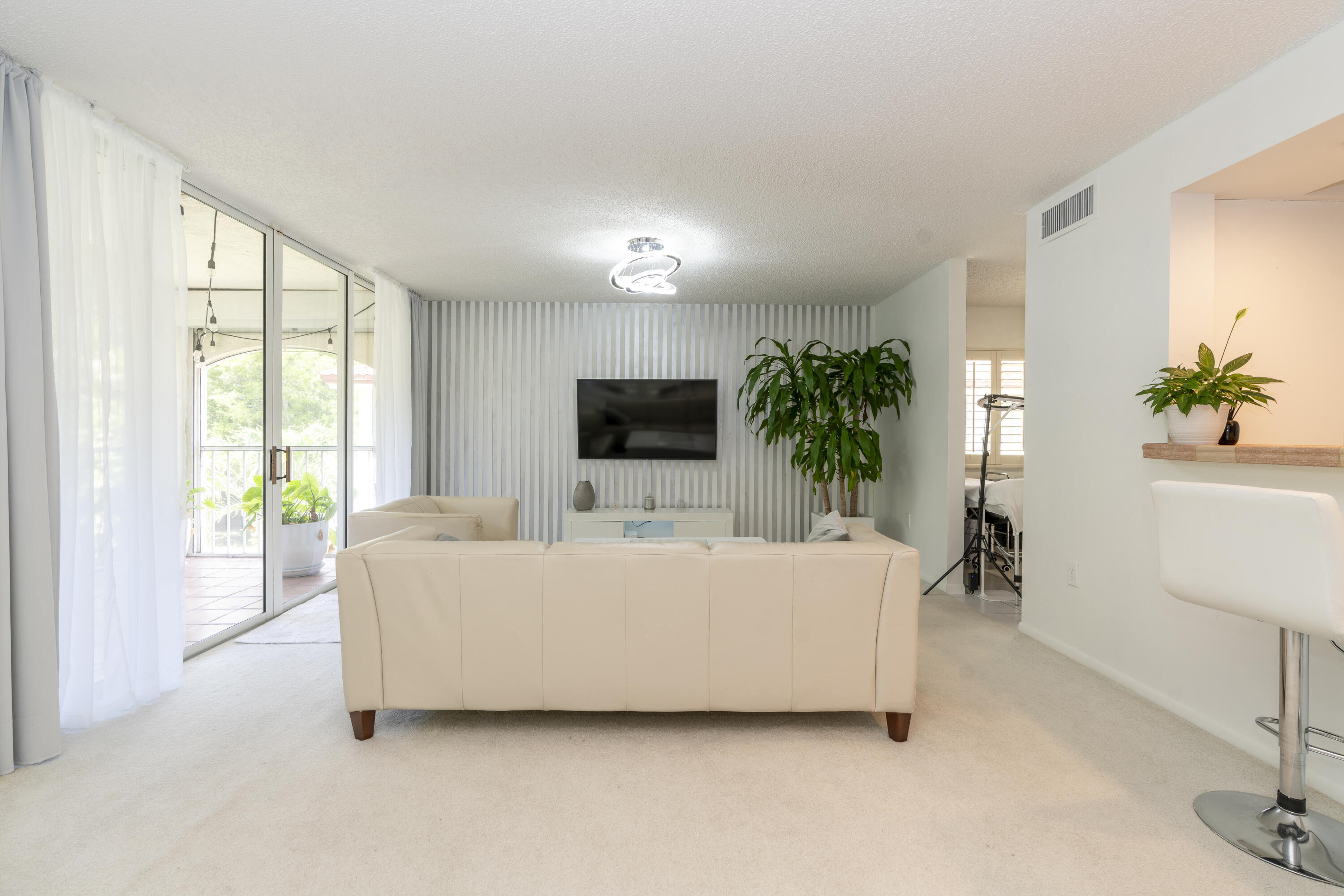 106 Half Moon Circle, Unit H2 Hypoluxo, FL 33462 - Photo 14 of 70 a living room with furniture and a flat screen tv