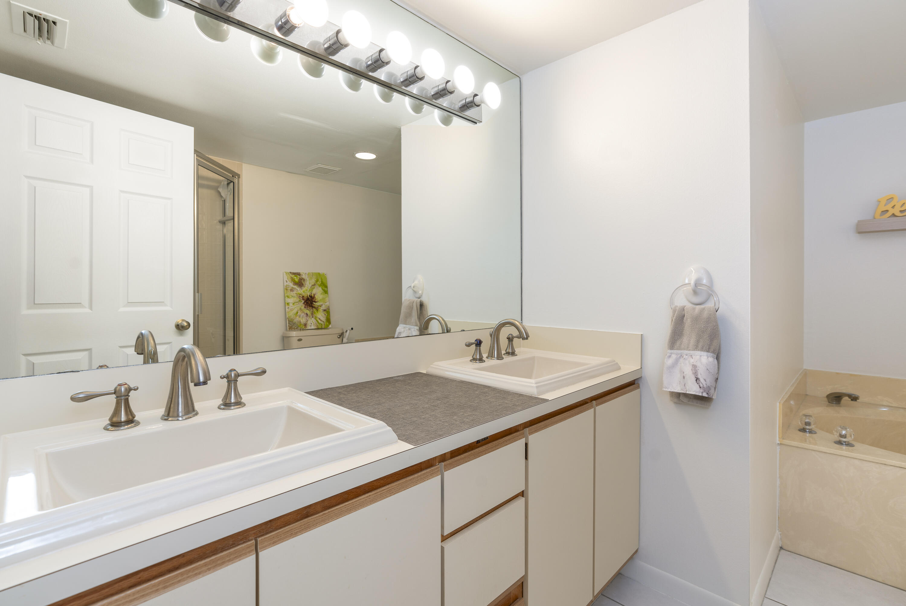 106 Half Moon Circle, Unit H2 Hypoluxo, FL 33462 - Photo 23 of 70 a bathroom with a sink and a mirror