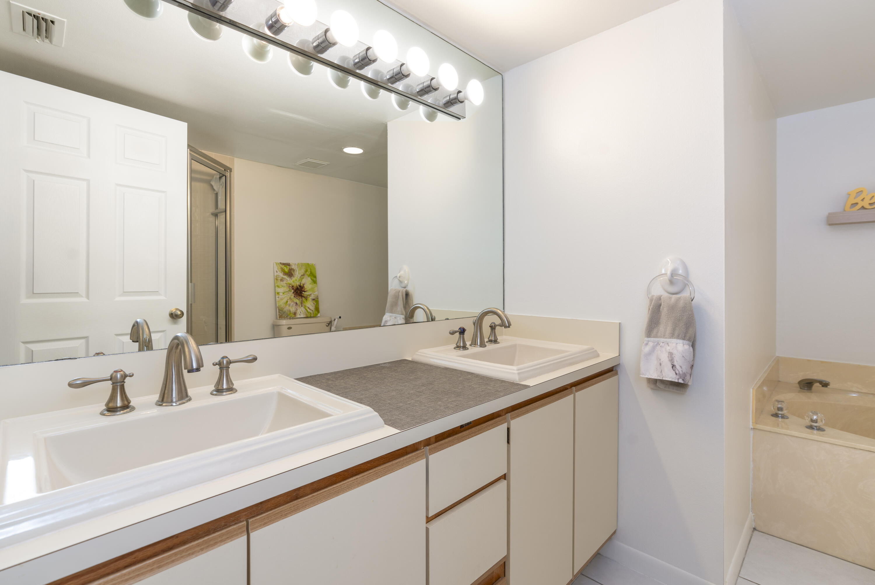 106 Half Moon Circle, Unit H2 Hypoluxo, FL 33462 - Photo 24 of 70 a bathroom with a sink and a mirror