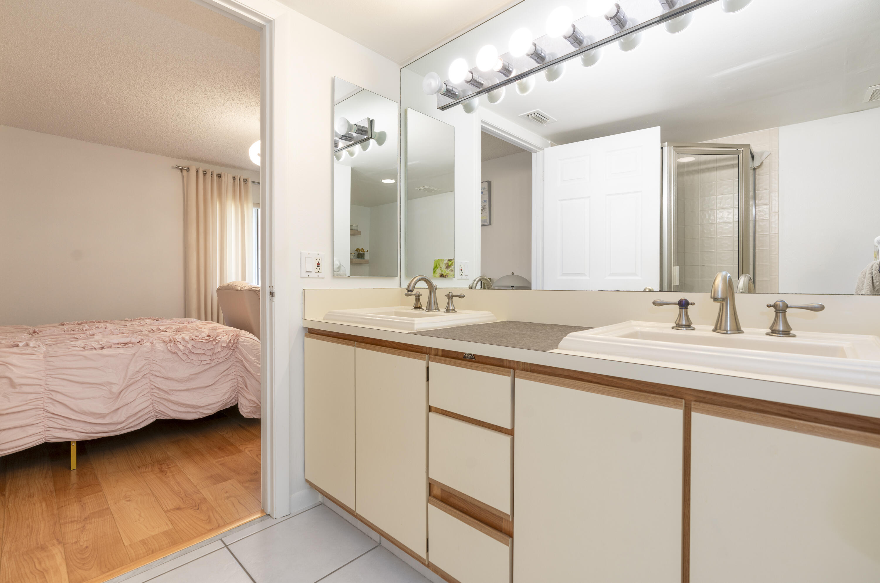 106 Half Moon Circle, Unit H2 Hypoluxo, FL 33462 - Photo 27 of 70 a en suite bathroom with double sink and a mirror