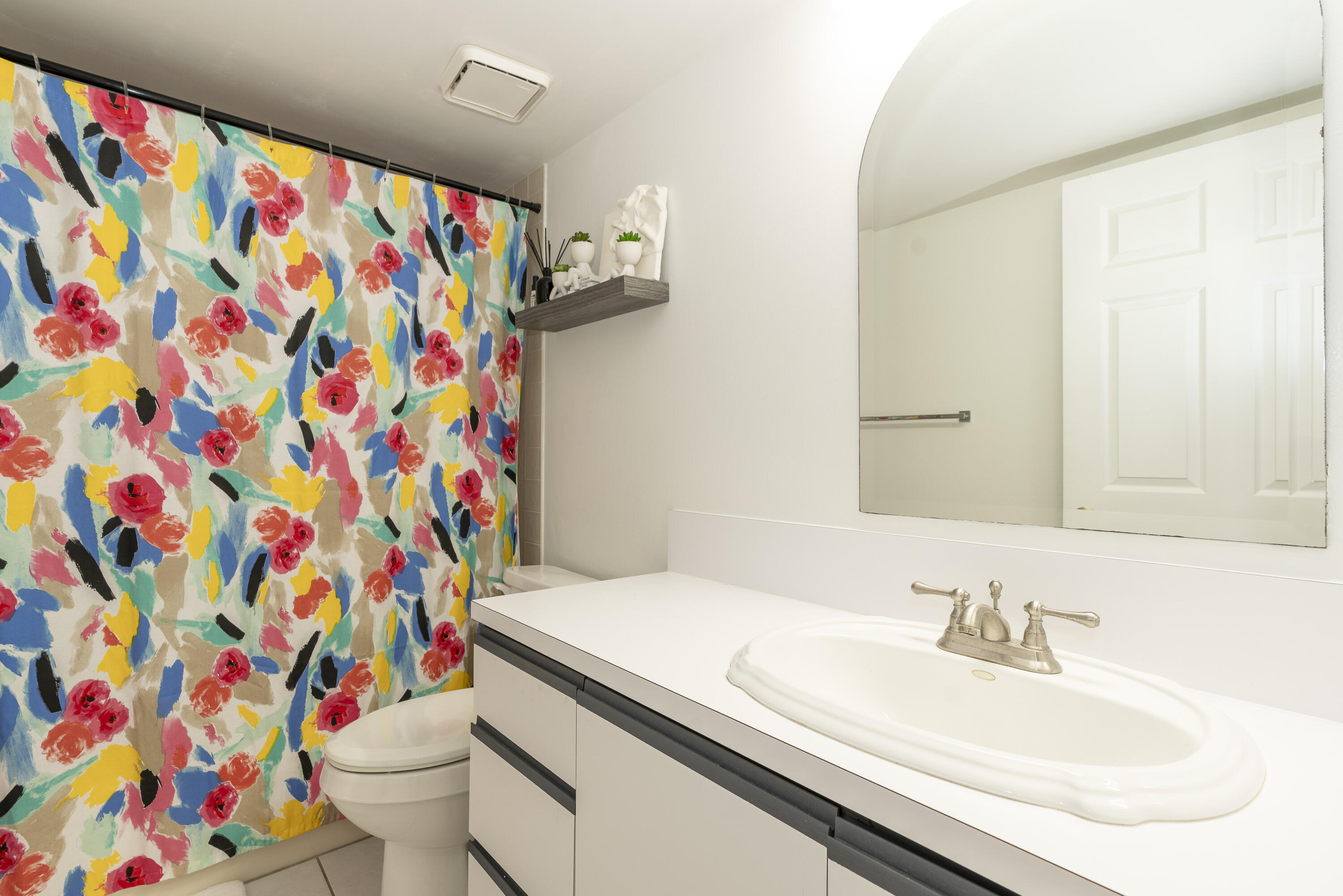 106 Half Moon Circle, Unit H2 Hypoluxo, FL 33462 - Photo 29 of 70 a bathroom with a sink toilet and vanity