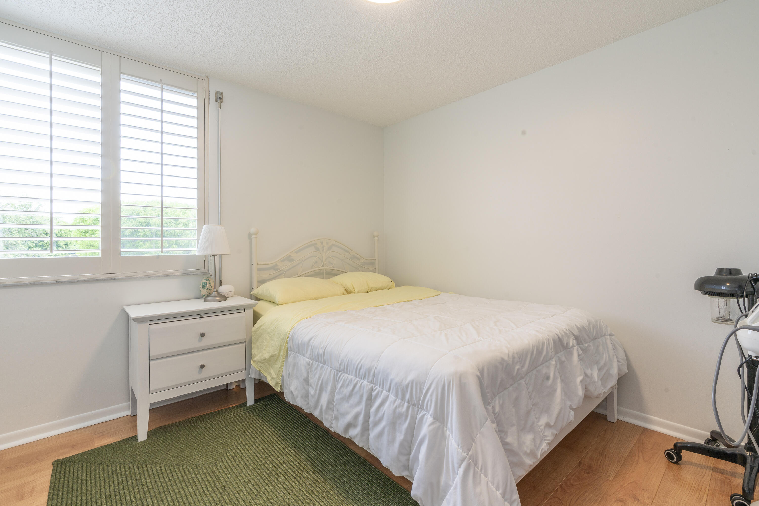 106 Half Moon Circle, Unit H2 Hypoluxo, FL 33462 - Photo 31 of 70 a bedroom with a bed and a window