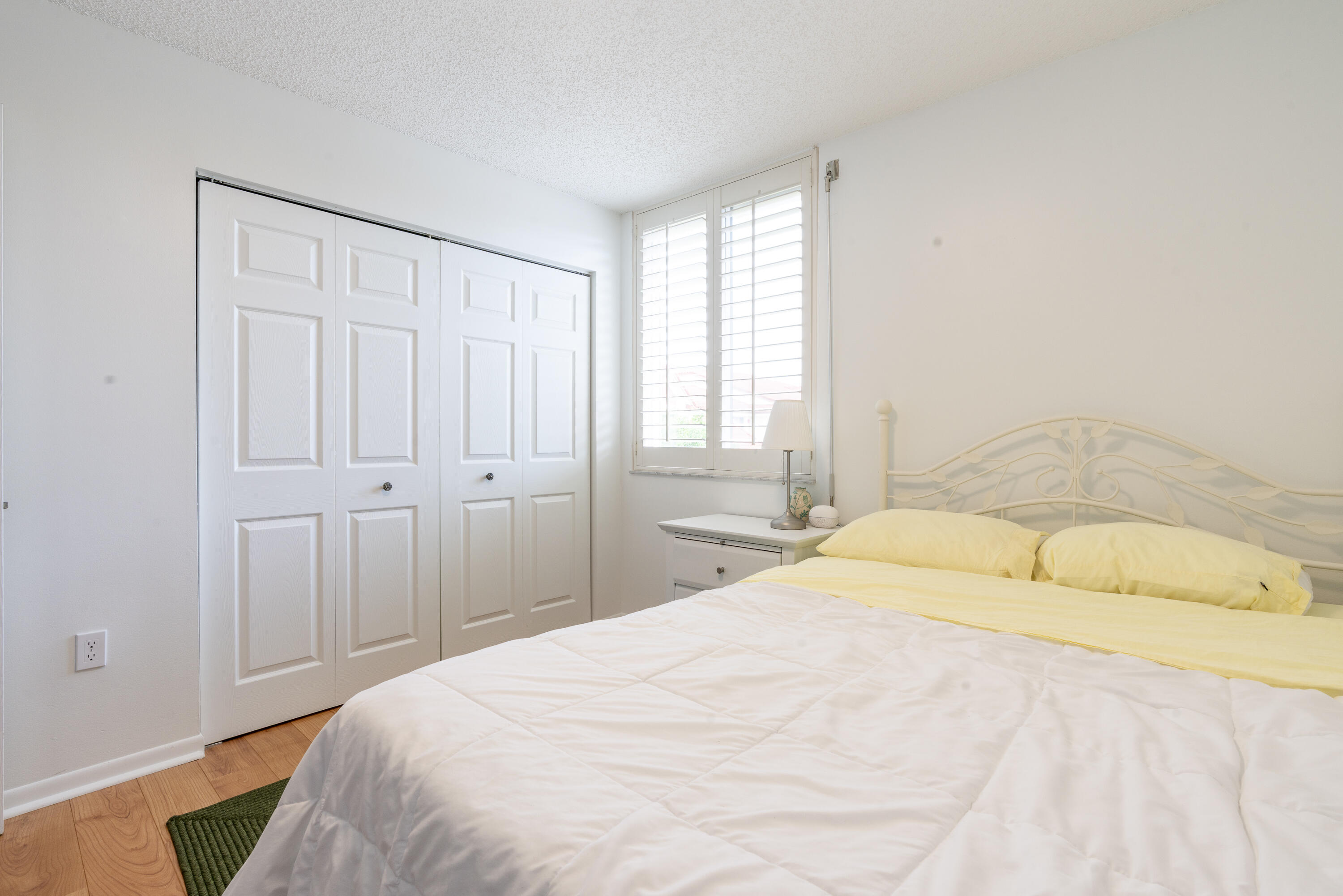 106 Half Moon Circle, Unit H2 Hypoluxo, FL 33462 - Photo 32 of 70 a bedroom with a bed and a window