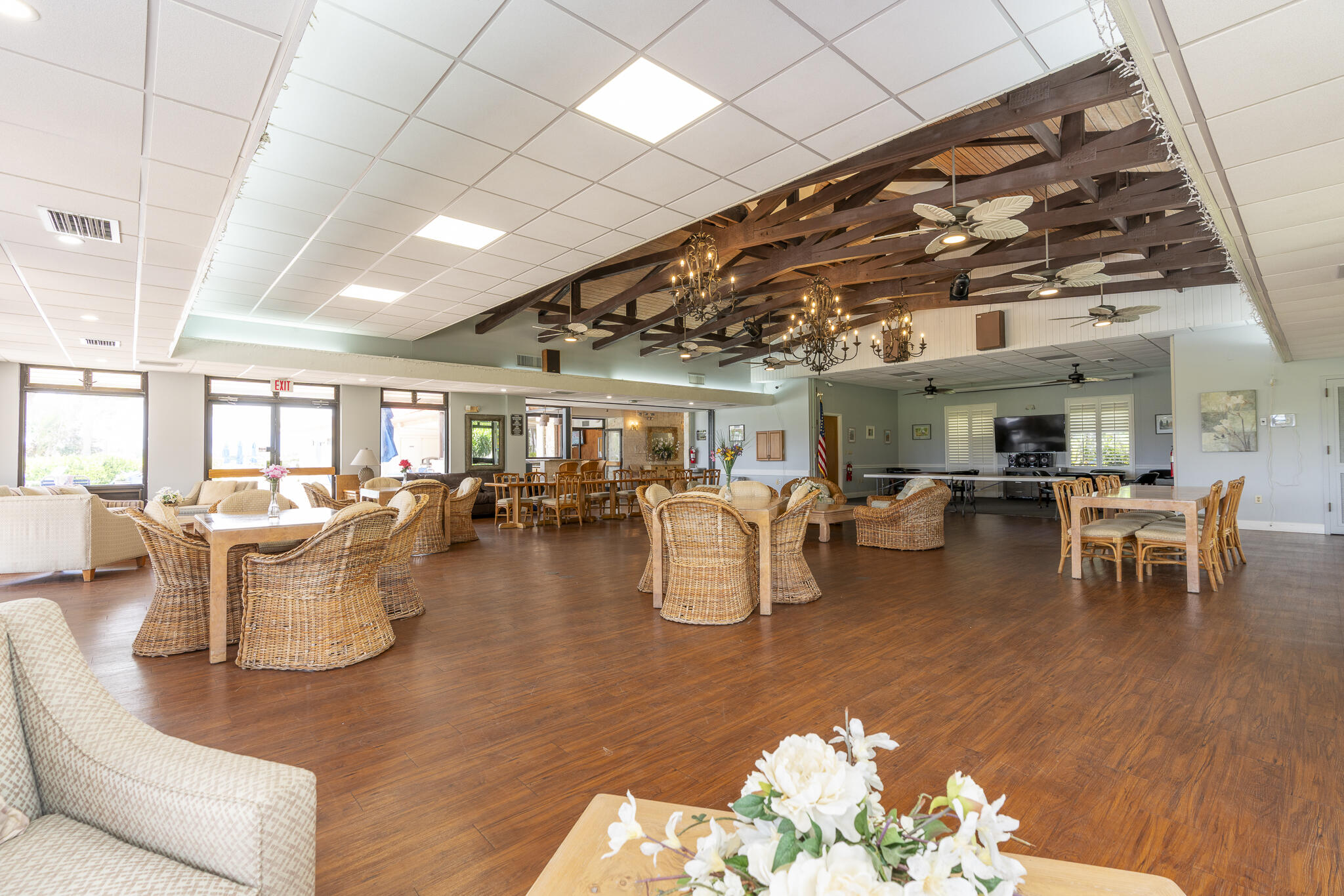 106 Half Moon Circle, Unit H2 Hypoluxo, FL 33462 - Photo 48 of 70 a living room with lots of furniture and a chandelier