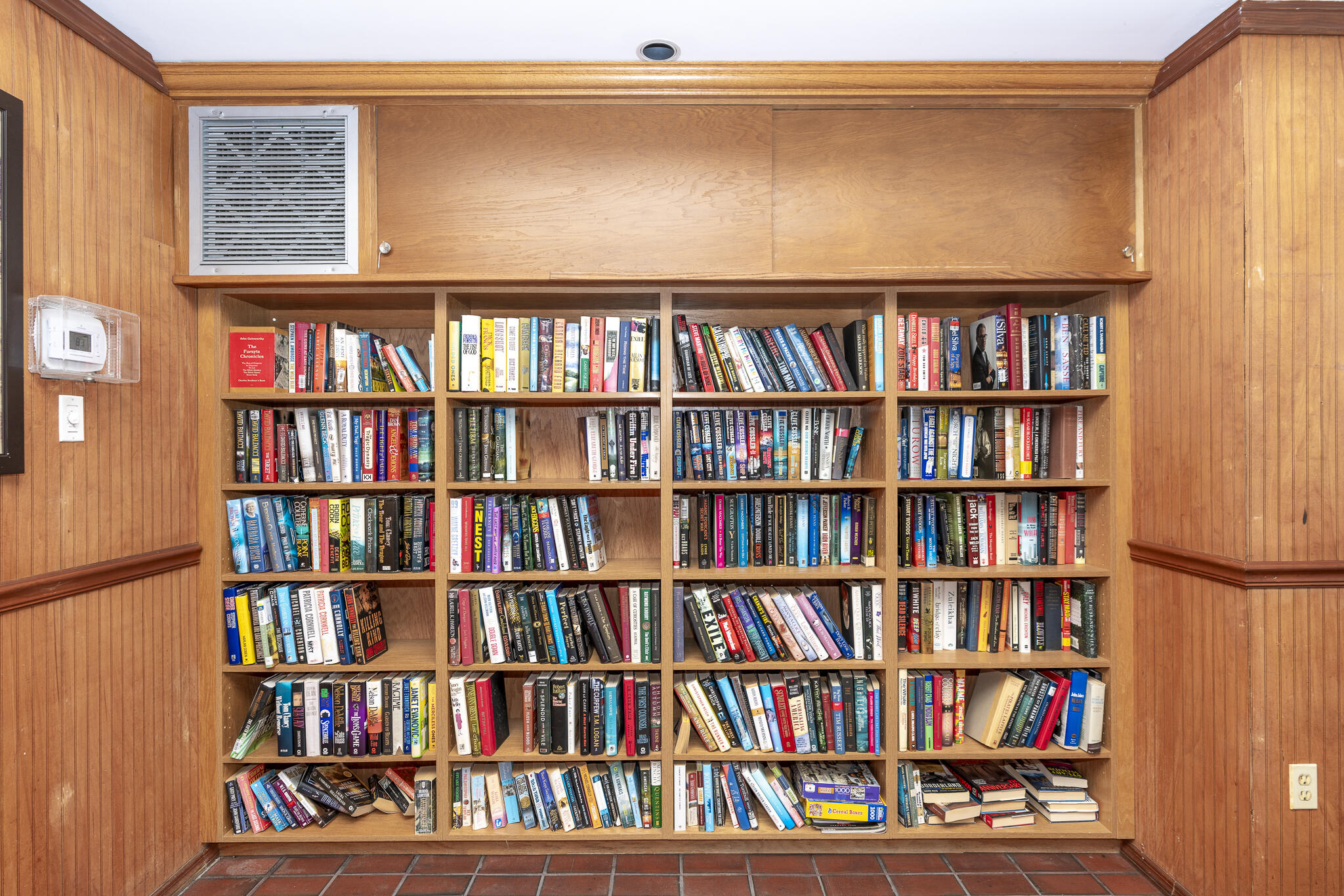106 Half Moon Circle, Unit H2 Hypoluxo, FL 33462 - Photo 55 of 70 a living room with furniture and a book shelf