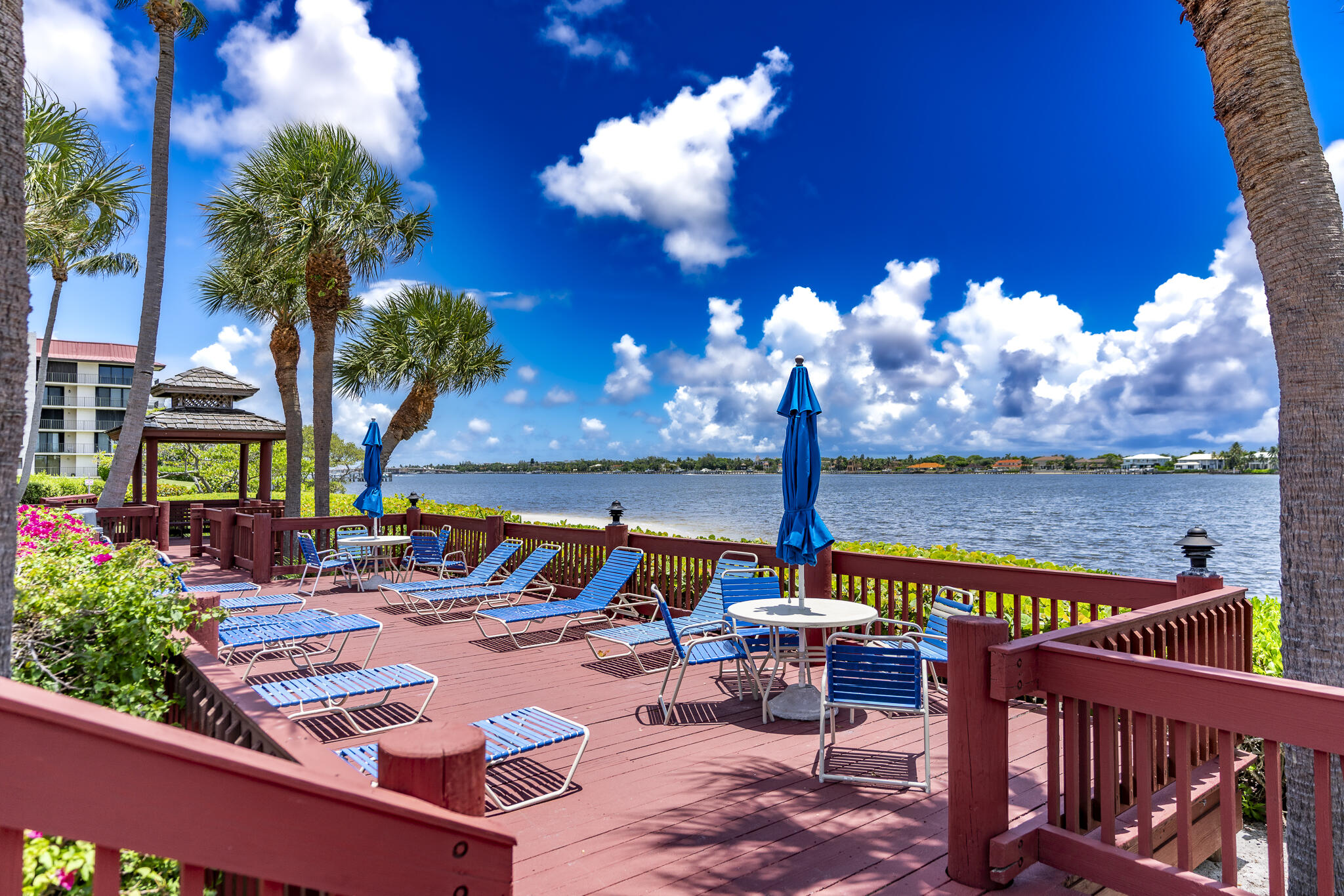 106 Half Moon Circle, Unit H2 Hypoluxo, FL 33462 - Photo 60 of 70 a view of swimming pool with a table and chairs under an umbrella