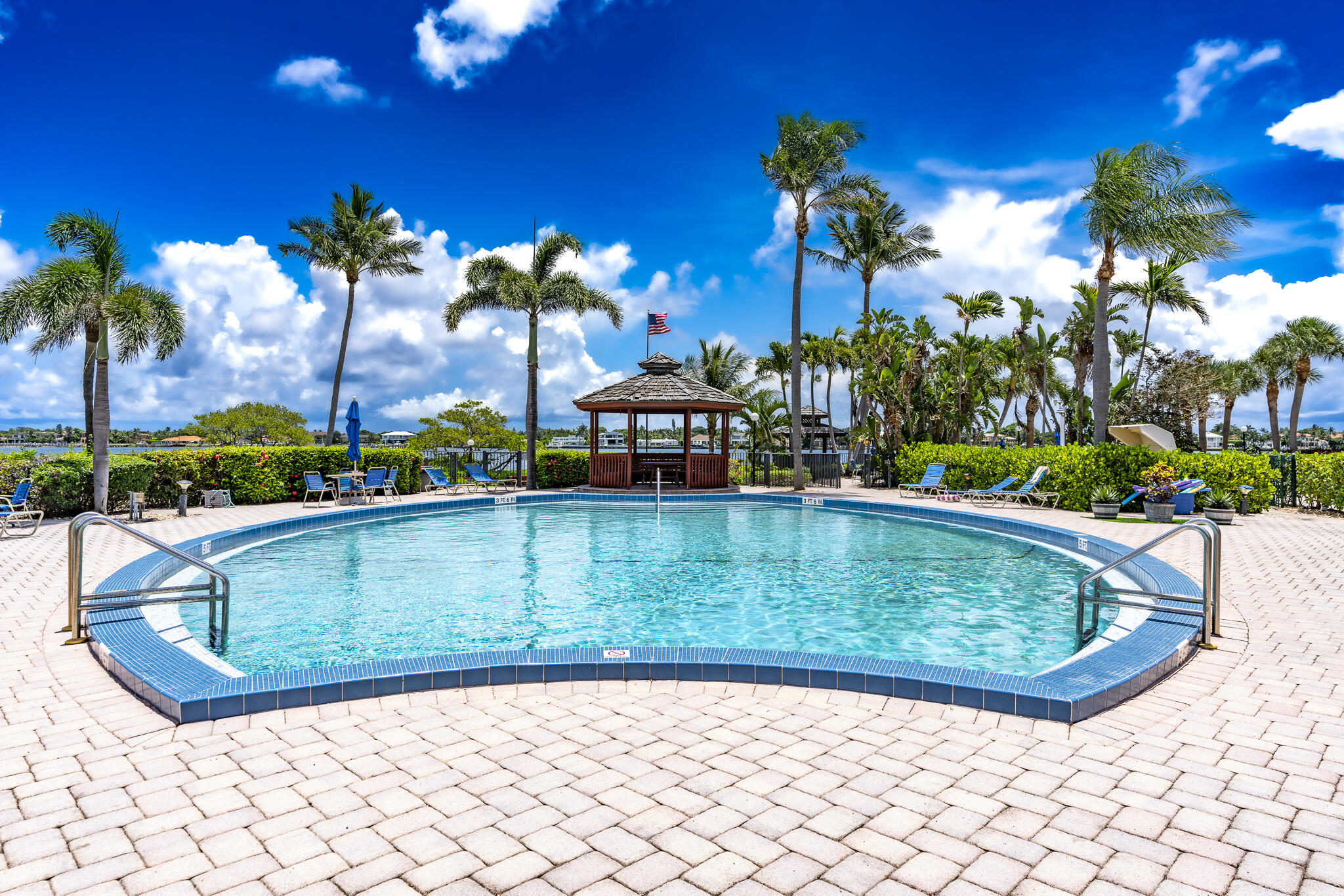 106 Half Moon Circle, Unit H2 Hypoluxo, FL 33462 - Photo 67 of 70 a view of a swimming pool with a lounge chairs