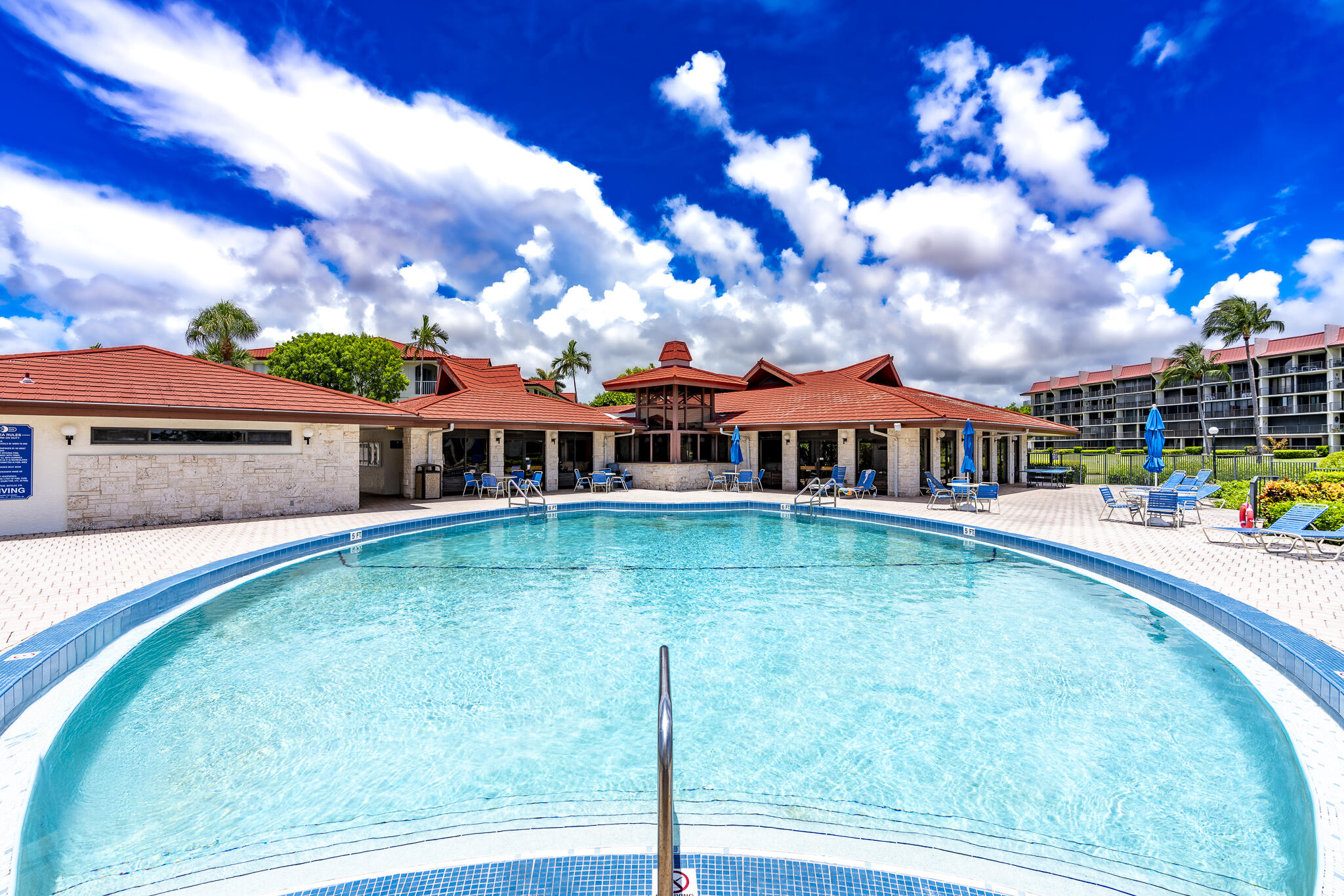 106 Half Moon Circle, Unit H2 Hypoluxo, FL 33462 - Photo 68 of 70 a front view of house with yard swimming pool and outdoor seating