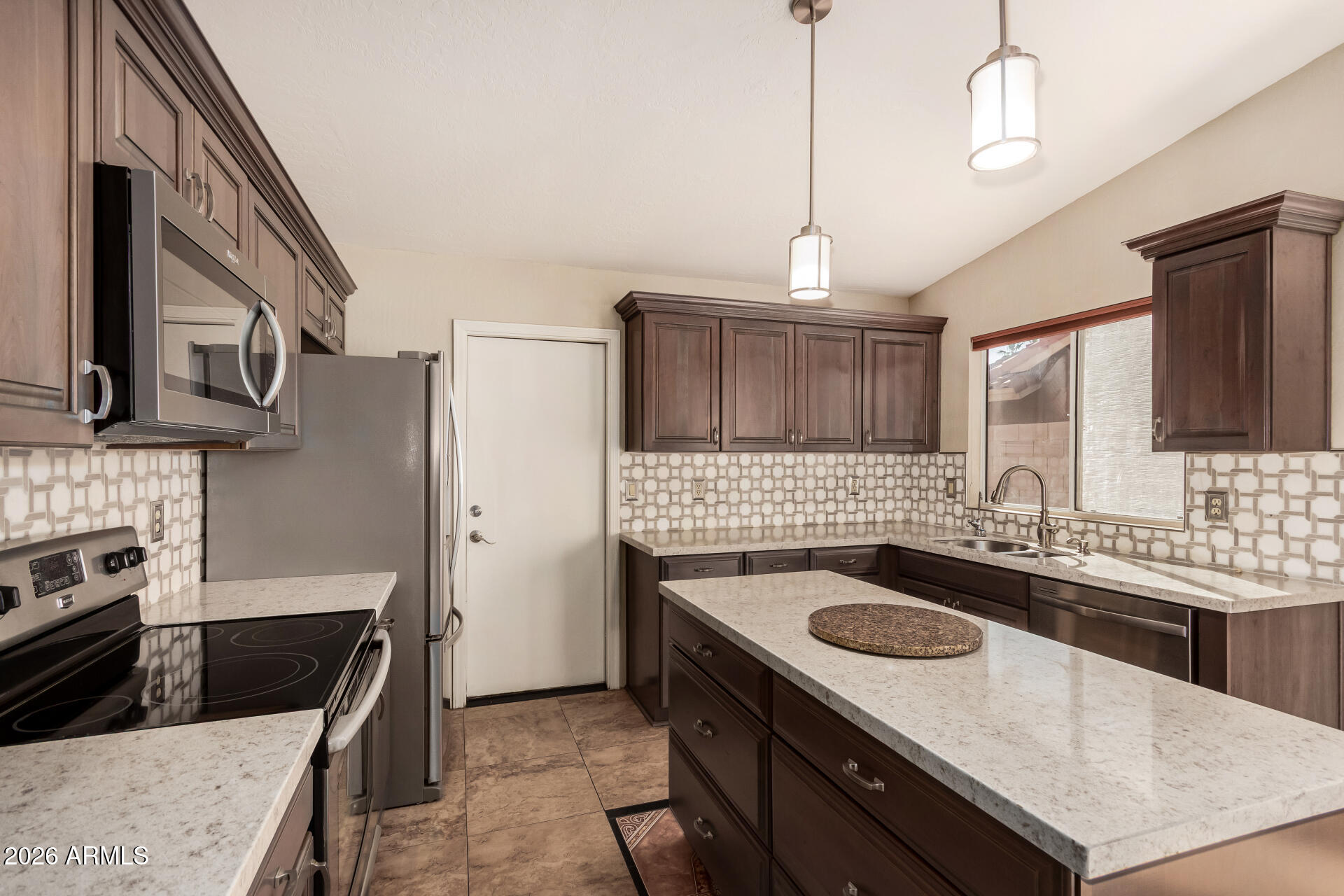 9152 West Redfield Road Peoria, AZ 85381 - Photo 2 of 21 a kitchen with stainless steel appliances granite countertop a sink stove and refrigerator