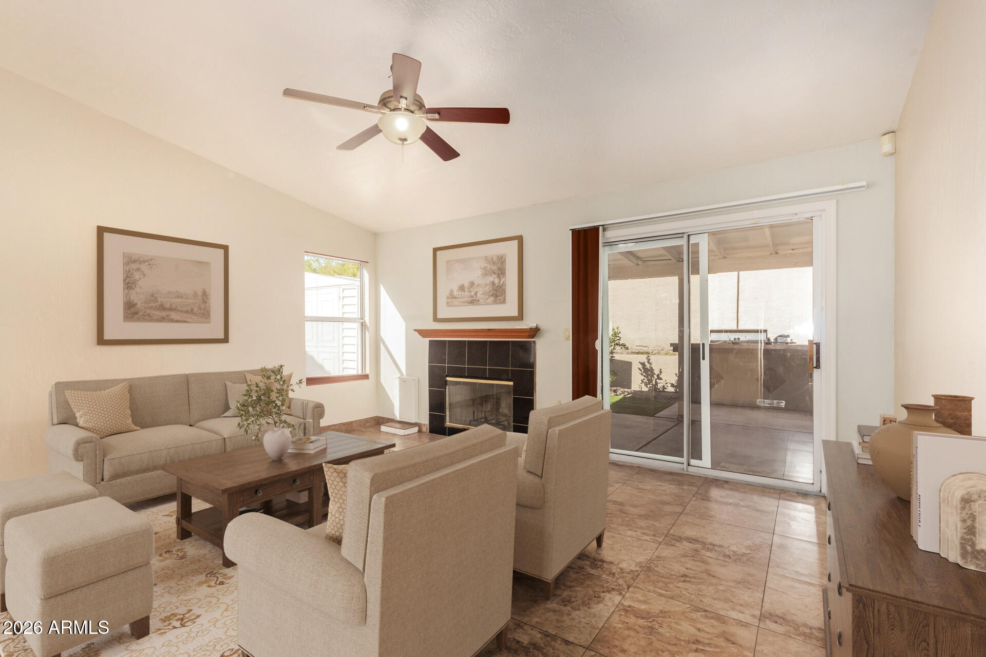 9152 West Redfield Road Peoria, AZ 85381 - Photo 3 of 21 a living room with furniture a fireplace and a floor to ceiling window
