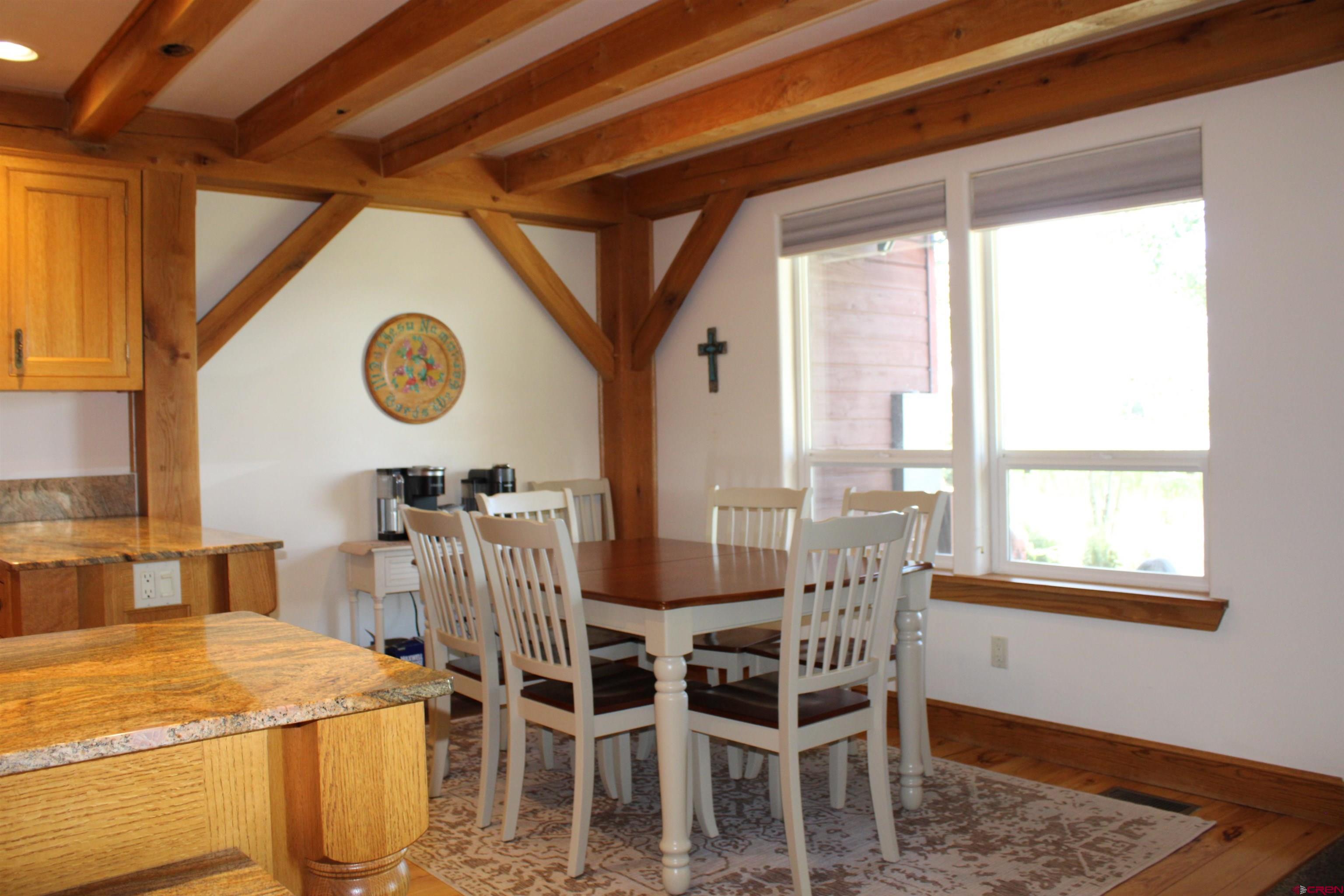 28 Holly Tree Circle Pagosa Springs, CO 81147 - Photo 15 of 27 a dining room with a wooden table and chairs