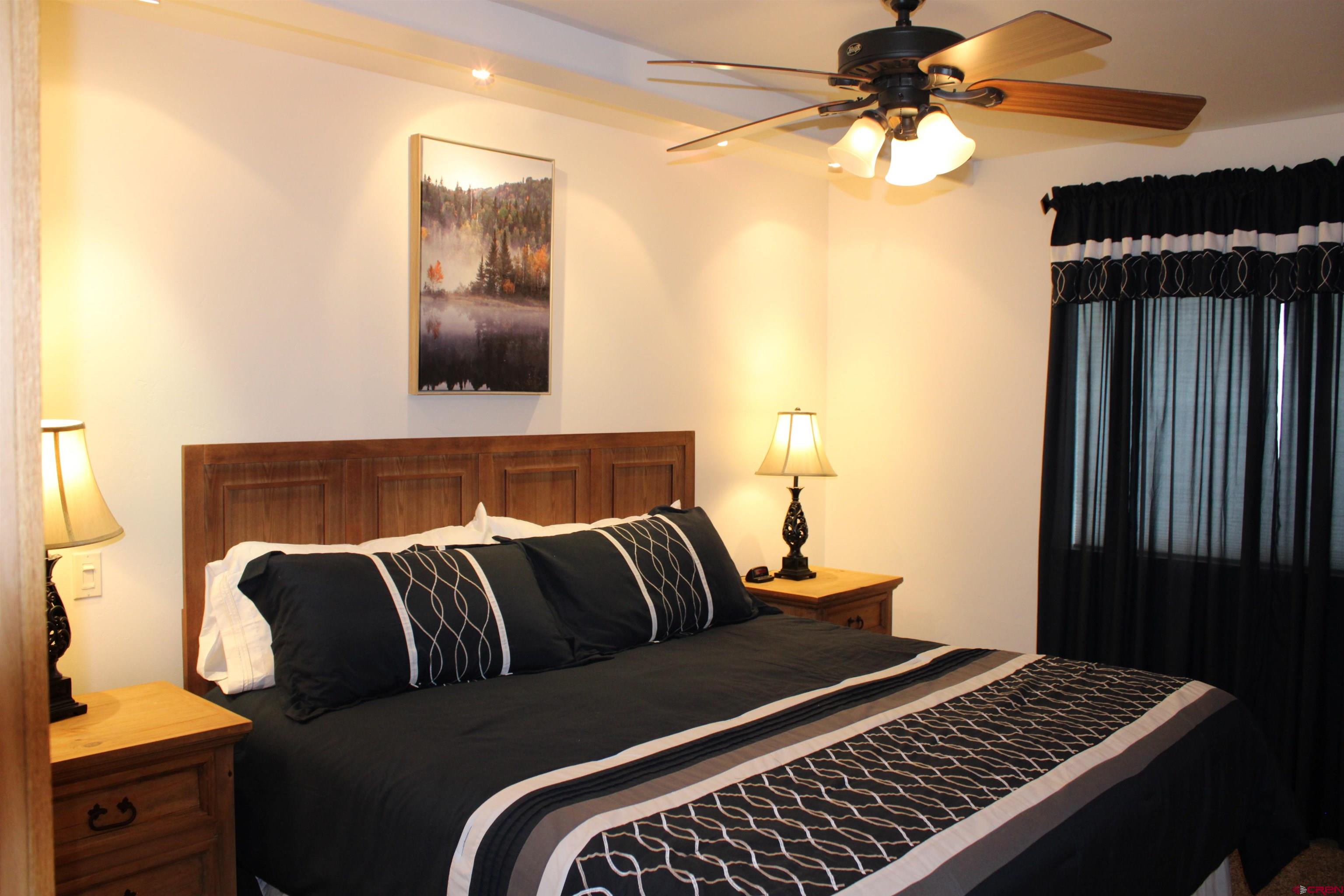 28 Holly Tree Circle Pagosa Springs, CO 81147 - Photo 16 of 27 a bedroom with a bed and wooden floor