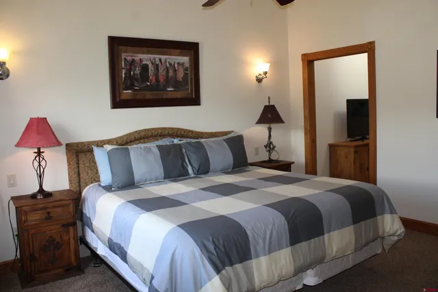 a bedroom with a bed and a flat screen tv