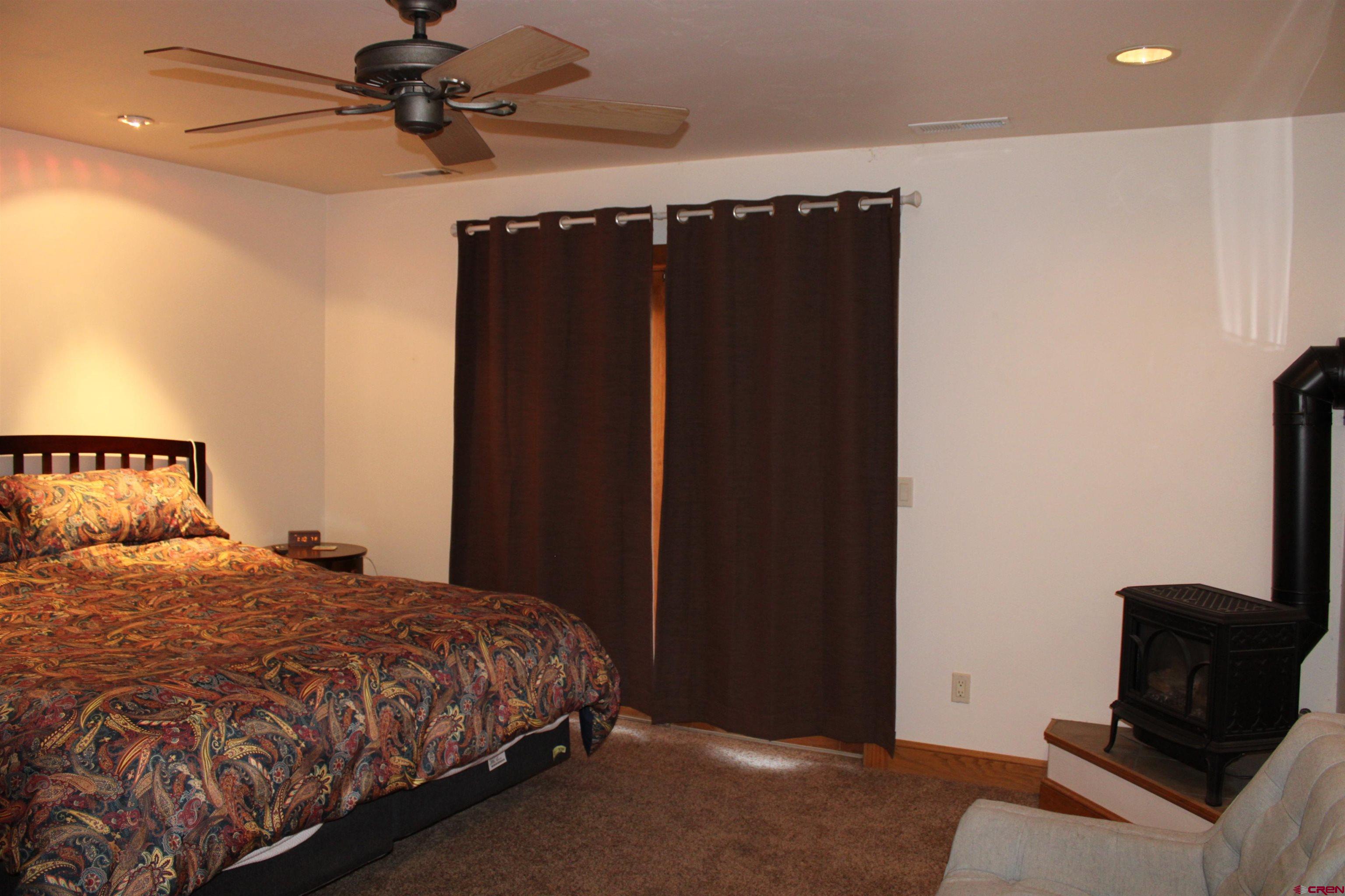 28 Holly Tree Circle Pagosa Springs, CO 81147 - Photo 22 of 27 a bedroom with a bed and a television