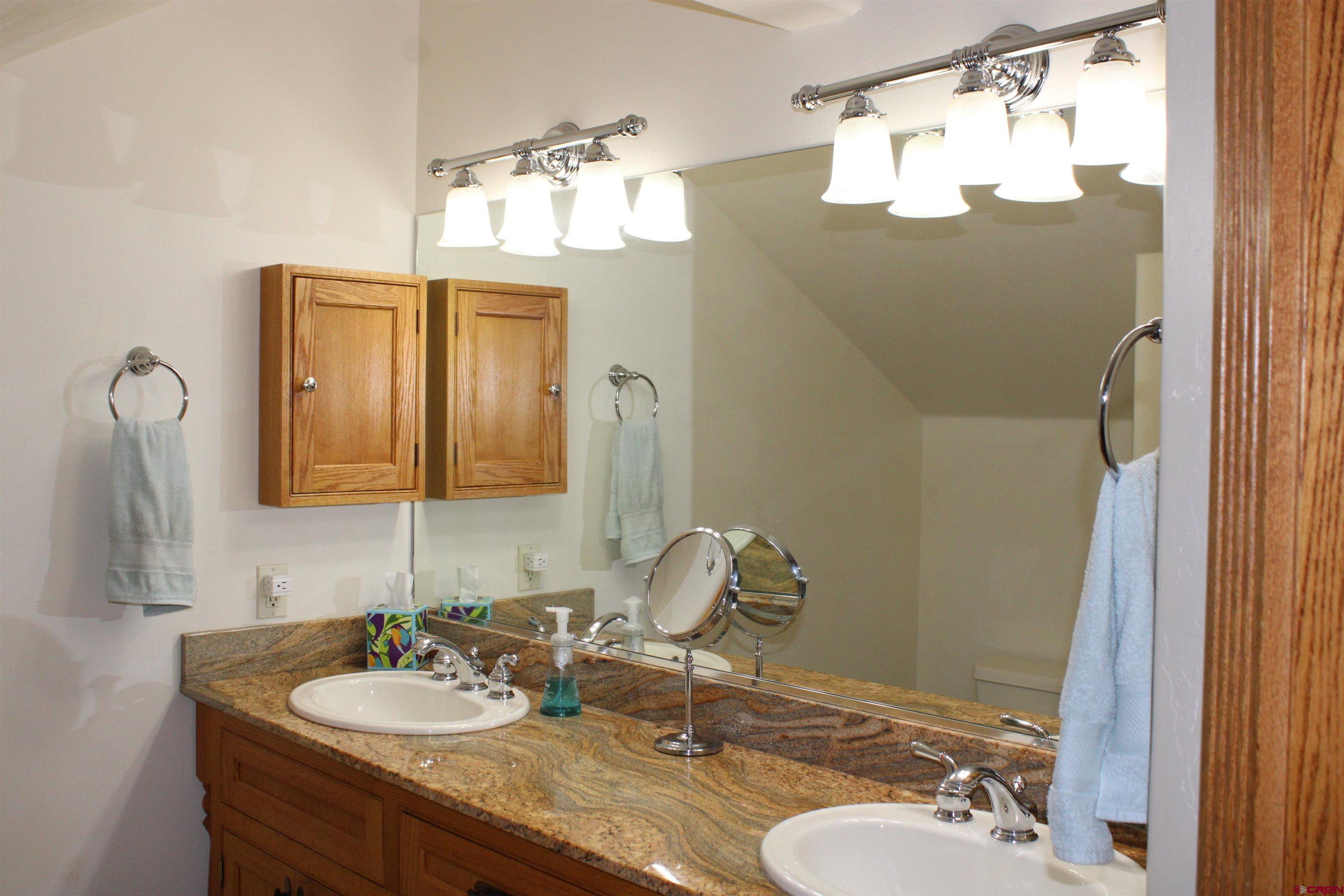 28 Holly Tree Circle Pagosa Springs, CO 81147 - Photo 23 of 27 a bathroom with a sink vanity and a mirror