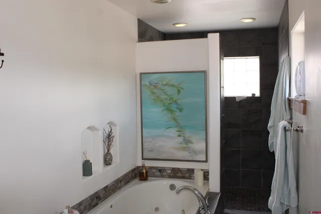 a bathroom with a tub and a sink