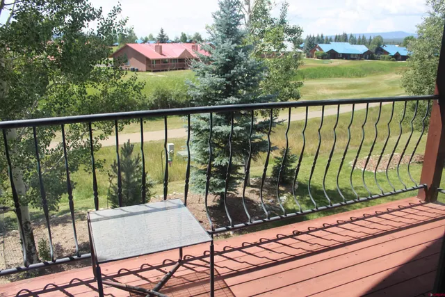 a view of a balcony with lake view and a floor to ceiling window