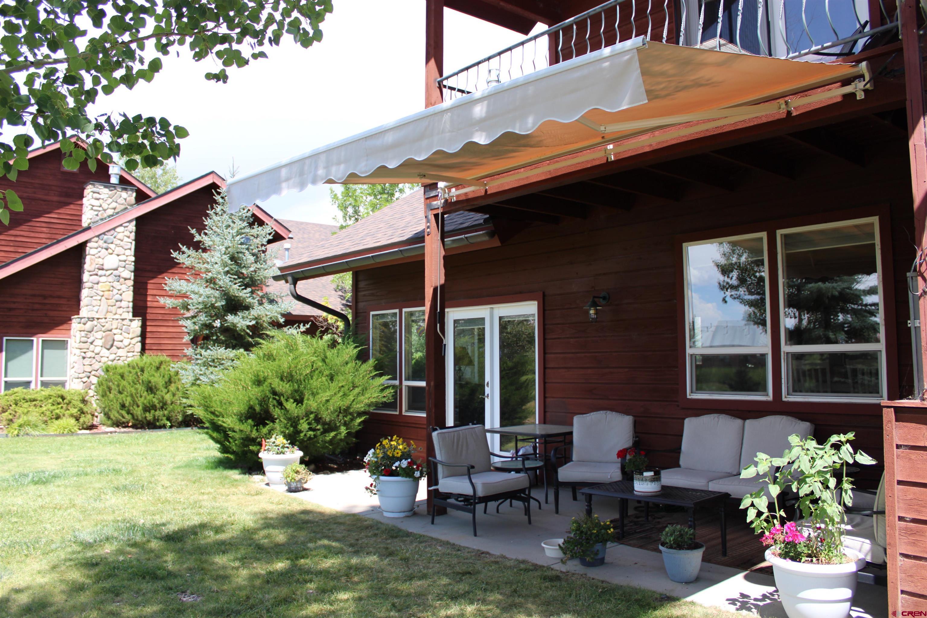28 Holly Tree Circle Pagosa Springs, CO 81147 - Photo 26 of 27 a patio with table and chairs and potted plants