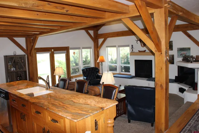 a dining room with a large window table and chairs