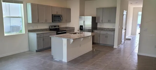 a kitchen with a sink stove and refrigerator