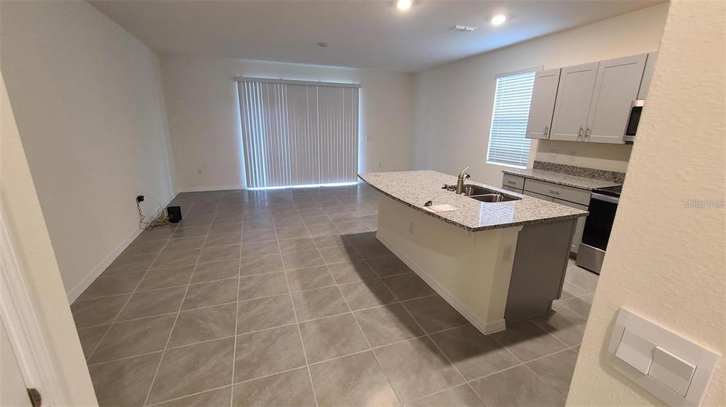 1310 Mako Way Kissimmee, FL 34741 - Photo 16 of 26 a bathroom with a sink a vanity and a mirror