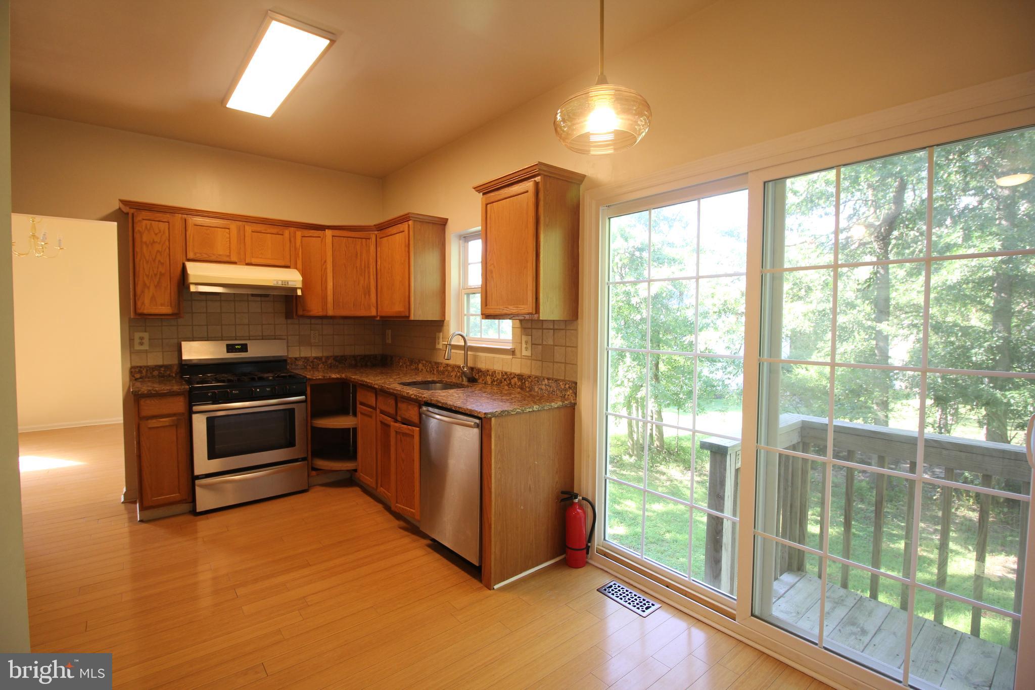 92 Harvard Circle Princeton, NJ 08540 - Photo 13 of 40 a kitchen with granite countertop a stove a sink and a refrigerator