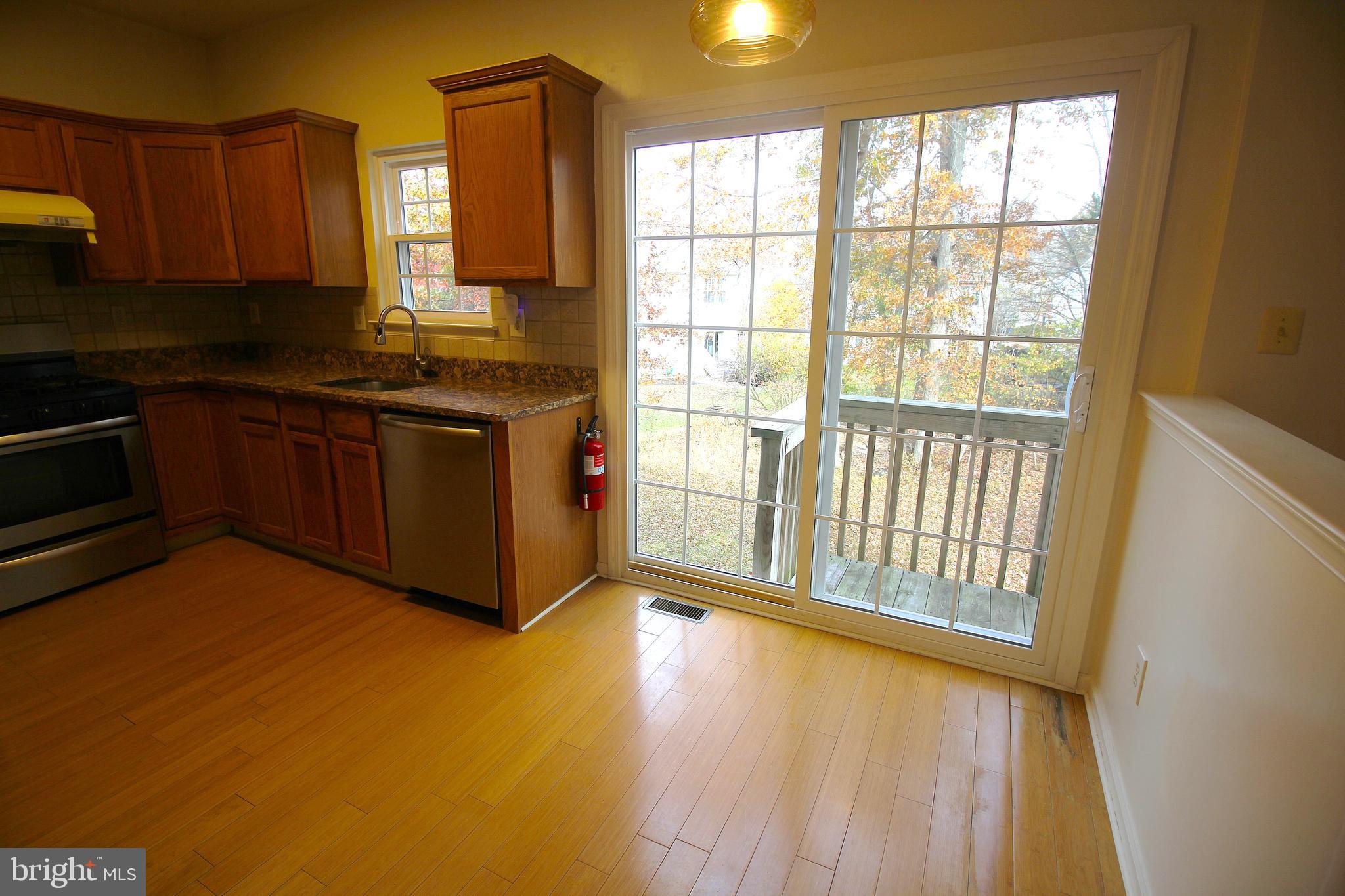 92 Harvard Circle Princeton, NJ 08540 - Photo 14 of 40 a kitchen with stainless steel appliances granite countertop a stove a sink and a microwave