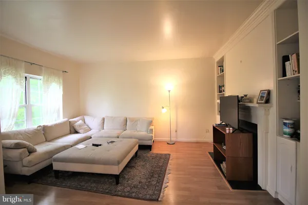 an empty room with a fireplace and windows