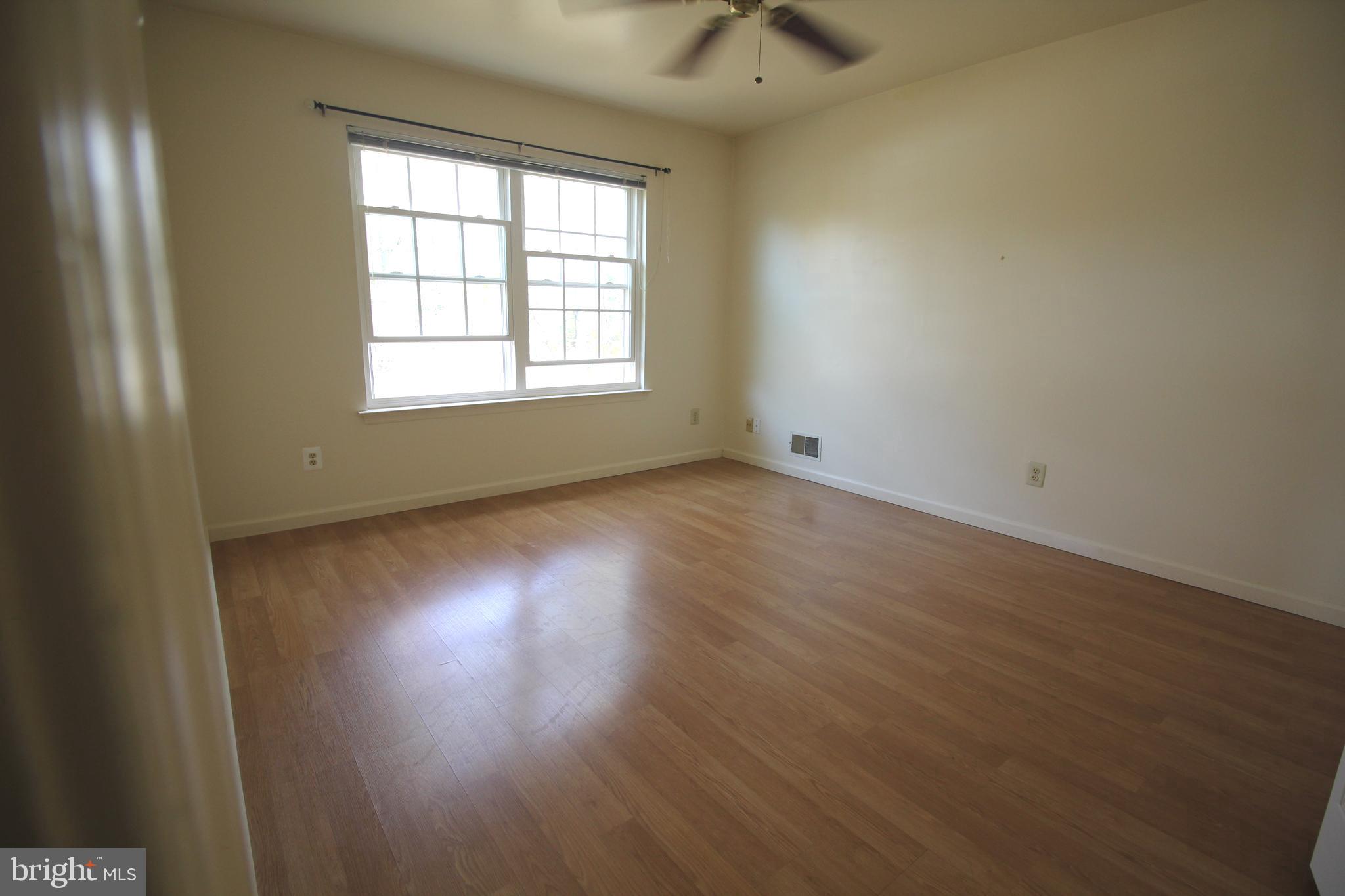92 Harvard Circle Princeton, NJ 08540 - Photo 20 of 40 an empty room with wooden floor and windows