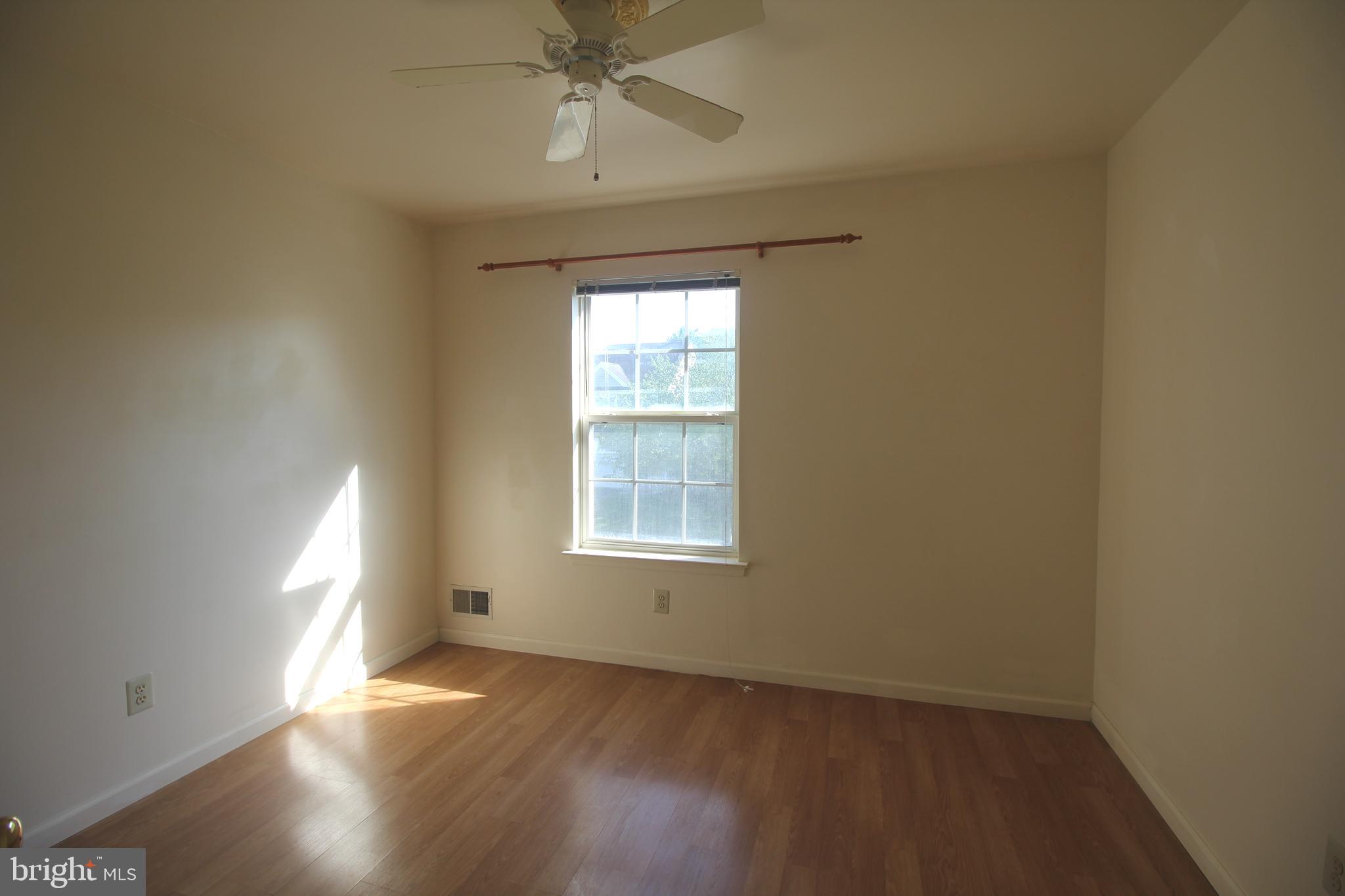 92 Harvard Circle Princeton, NJ 08540 - Photo 22 of 40 an empty room with wooden floor chandelier fan and windows