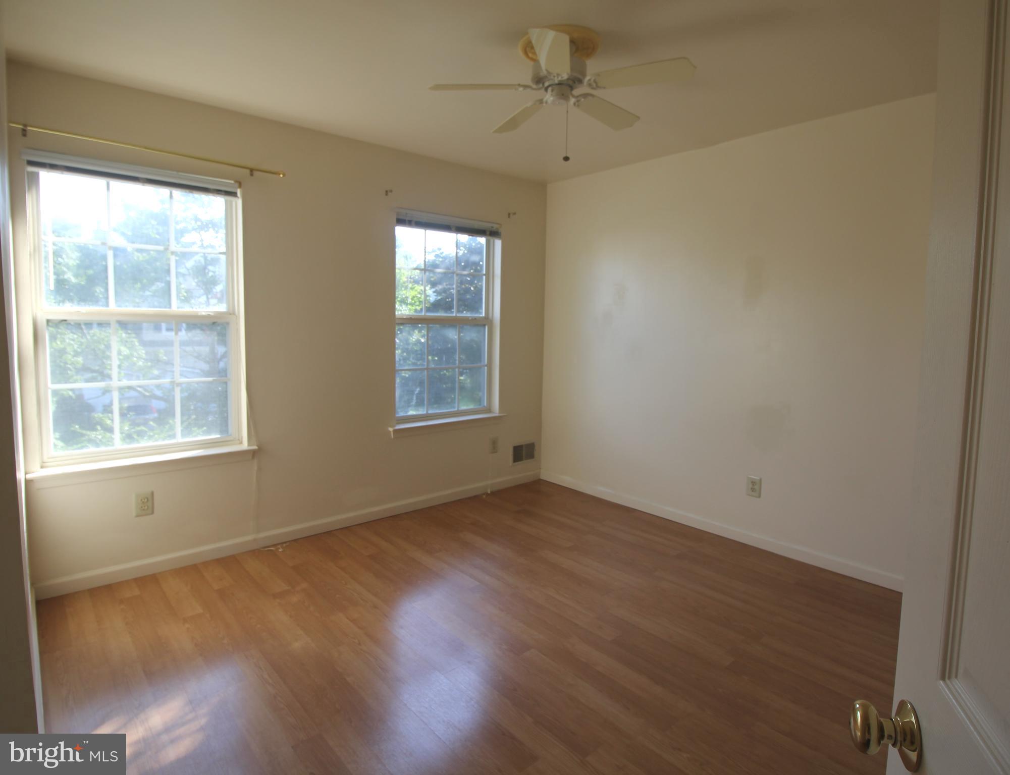 92 Harvard Circle Princeton, NJ 08540 - Photo 23 of 40 an empty room with wooden floor fan and windows