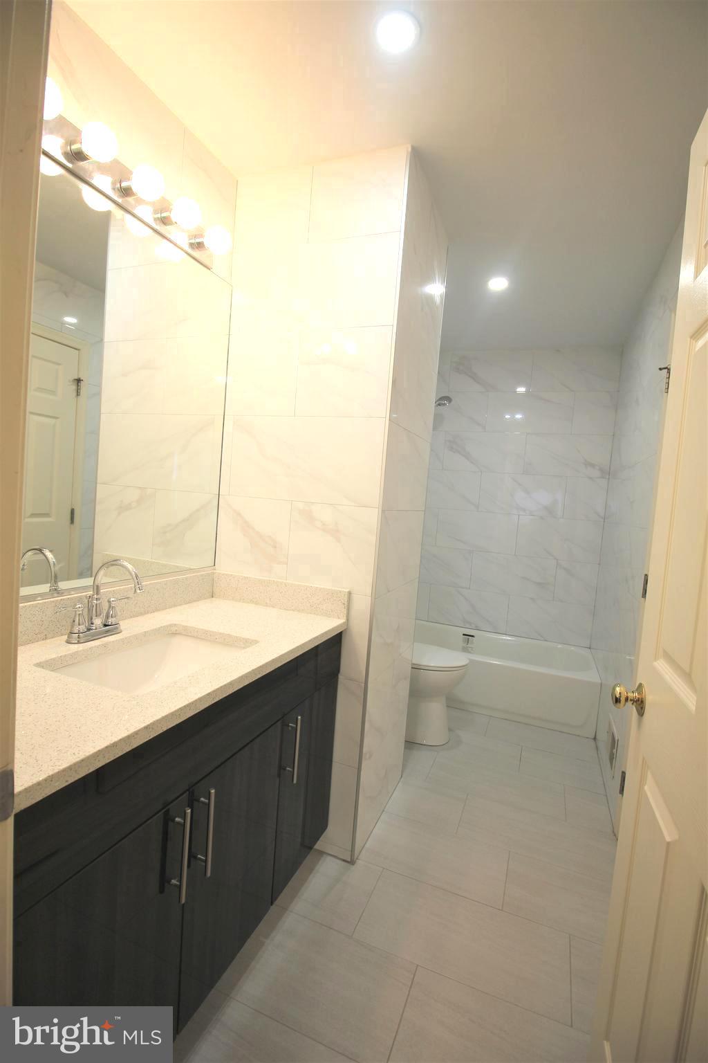 92 Harvard Circle Princeton, NJ 08540 - Photo 25 of 40 a bathroom with a double vanity sink toilet and shower