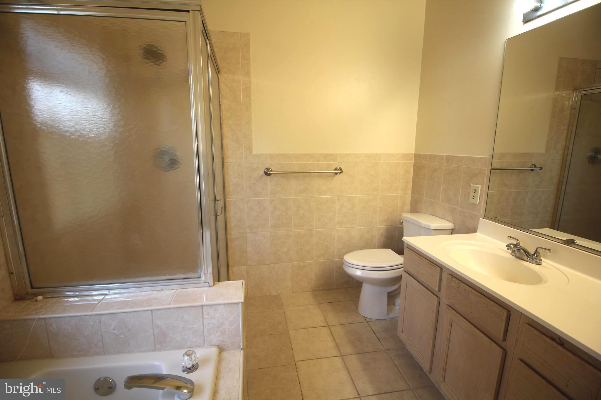 92 Harvard Circle Princeton, NJ 08540 - Photo 29 of 40 a bathroom with a granite countertop sink toilet and shower