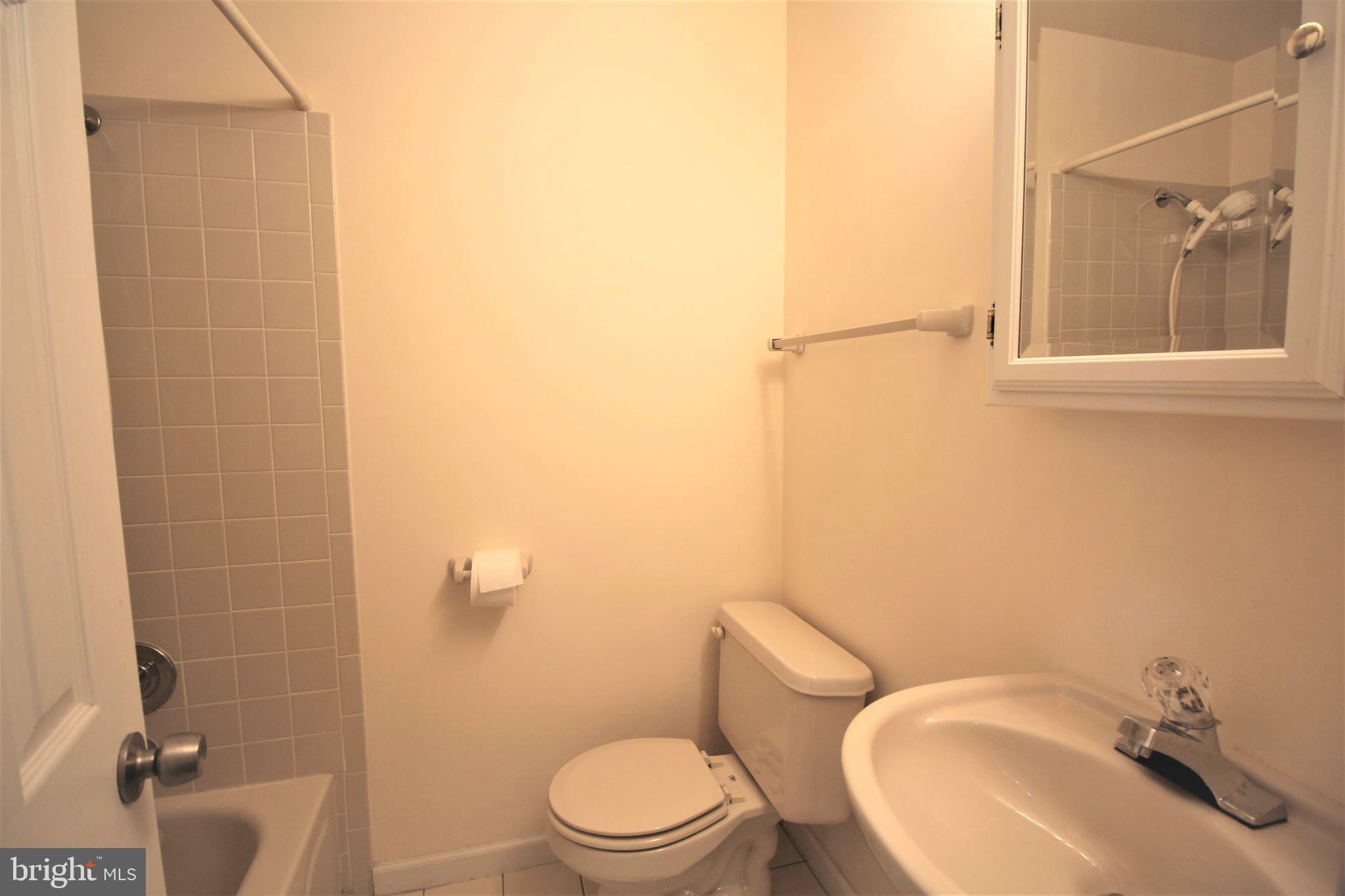 92 Harvard Circle Princeton, NJ 08540 - Photo 33 of 40 a white toilet sitting next to a bathroom sink