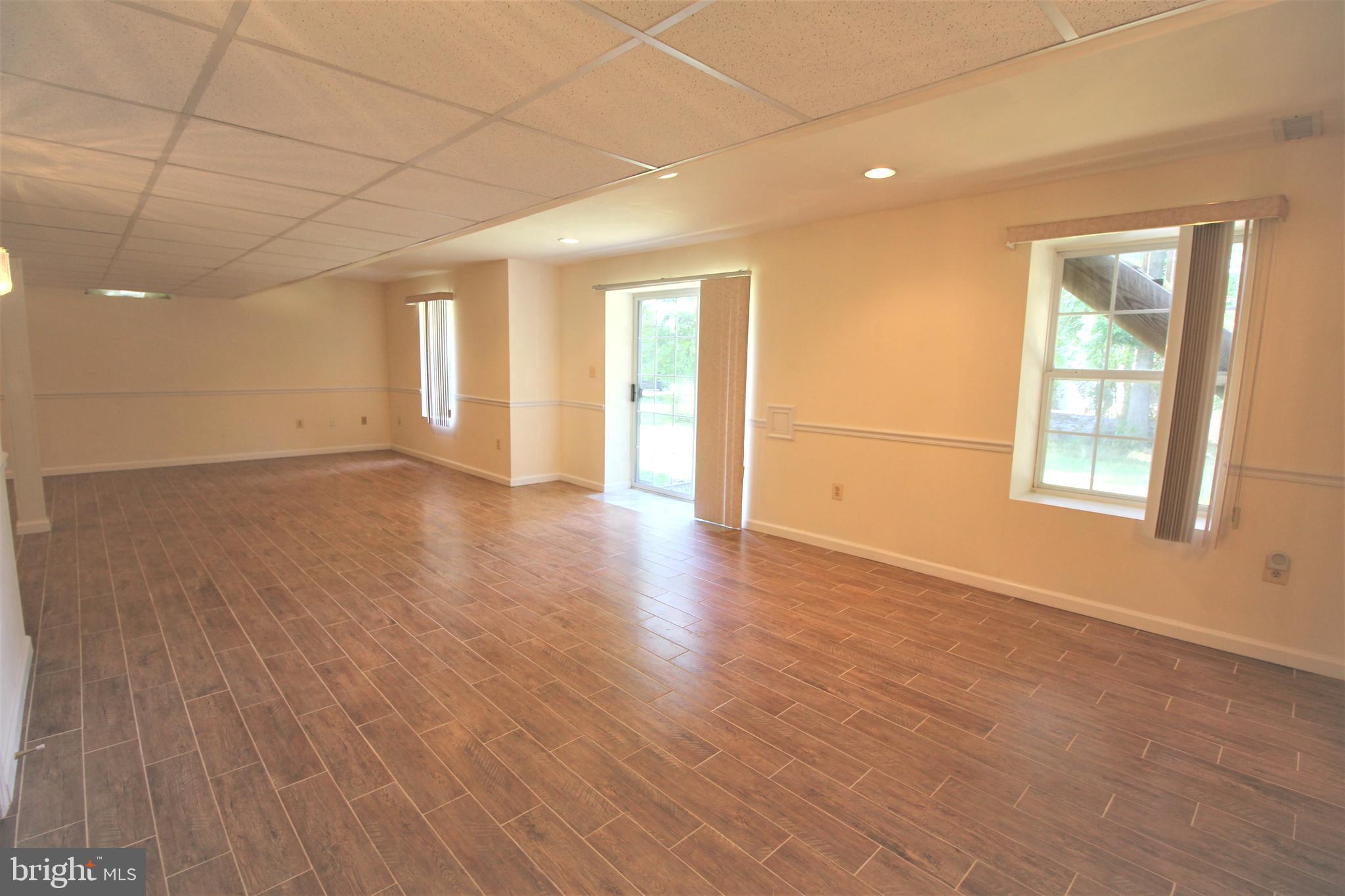 92 Harvard Circle Princeton, NJ 08540 - Photo 35 of 40 an empty room with wooden floor and windows