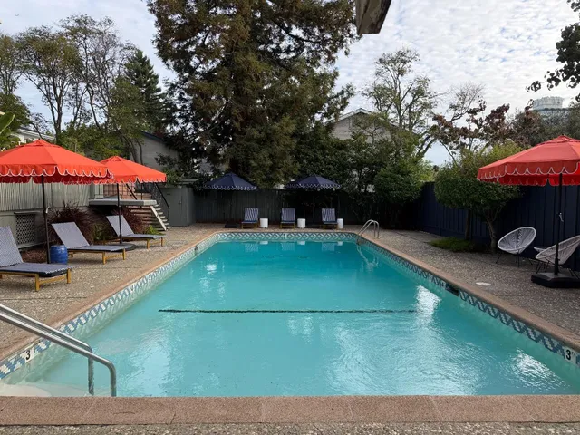 an outdoor space with pool and furniture