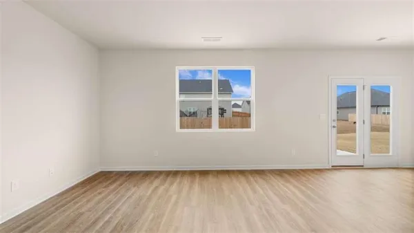 a view of kitchen with kitchen island stainless steel appliances wooden floor and living room view