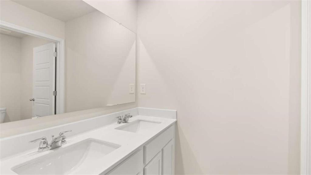 202 Cattle Drive Perry, GA 31069 - Photo 22 of 30 a bathroom with a double vanity sink and a mirror