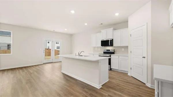 a view of a kitchen with sink and microwave