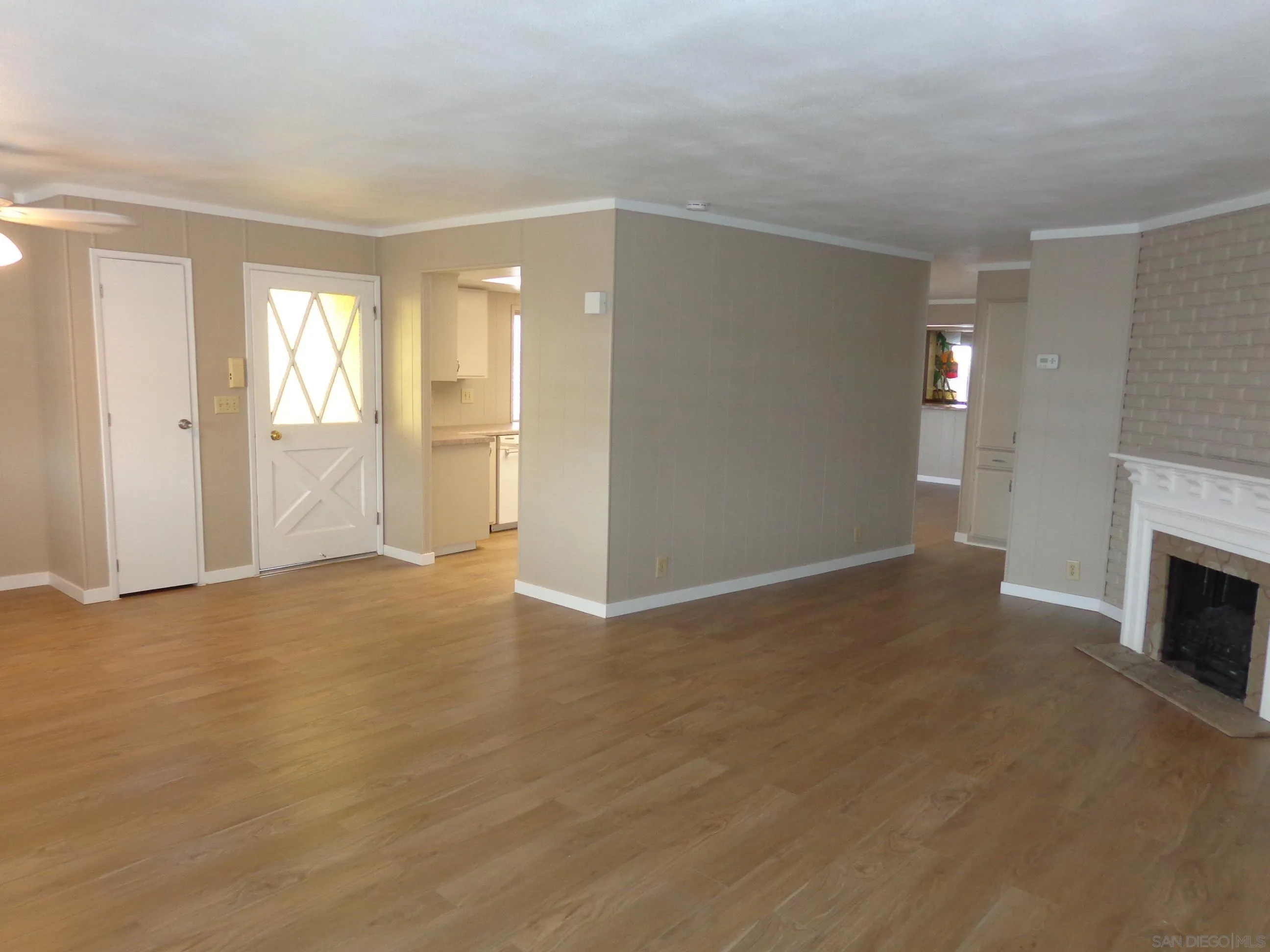 106 Havenview Lane Oceanside, CA 92056 - Photo 8 of 24 a view of livingroom with hardwood floor and fireplace