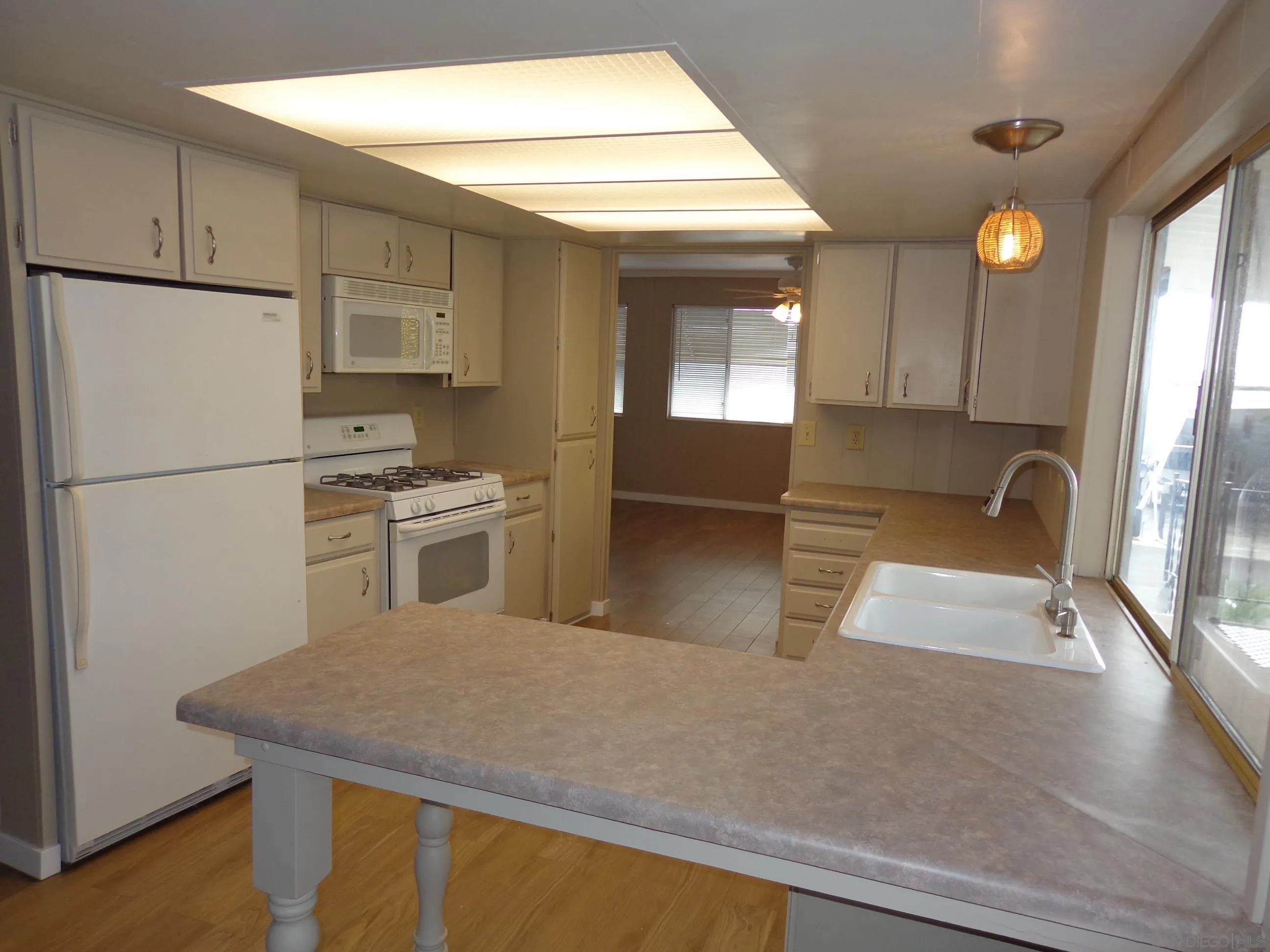 106 Havenview Lane Oceanside, CA 92056 - Photo 10 of 24 a kitchen with stainless steel appliances granite countertop a sink refrigerator and cabinets