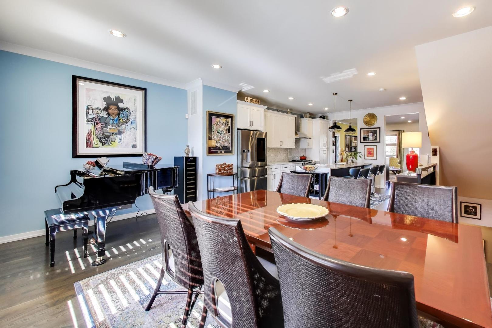 347 East 44th Street Chicago, IL 60653 - Photo 12 of 38 a dining area with stainless steel appliances kitchen island granite countertop a dining table chairs and a refrigerator