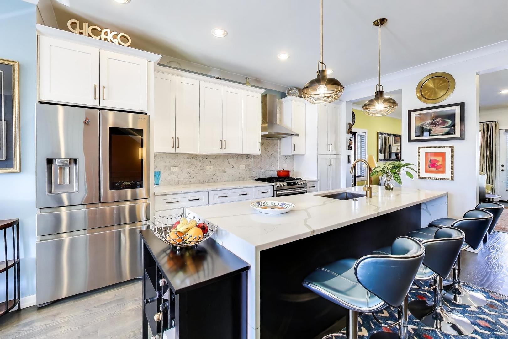 347 East 44th Street Chicago, IL 60653 - Photo 14 of 38 a kitchen with stainless steel appliances a dining table chairs stove and refrigerator