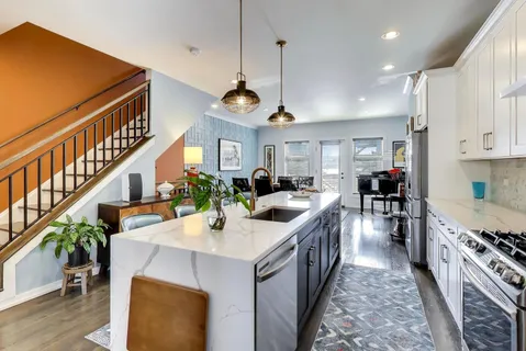 a kitchen with sink stove and cabinets