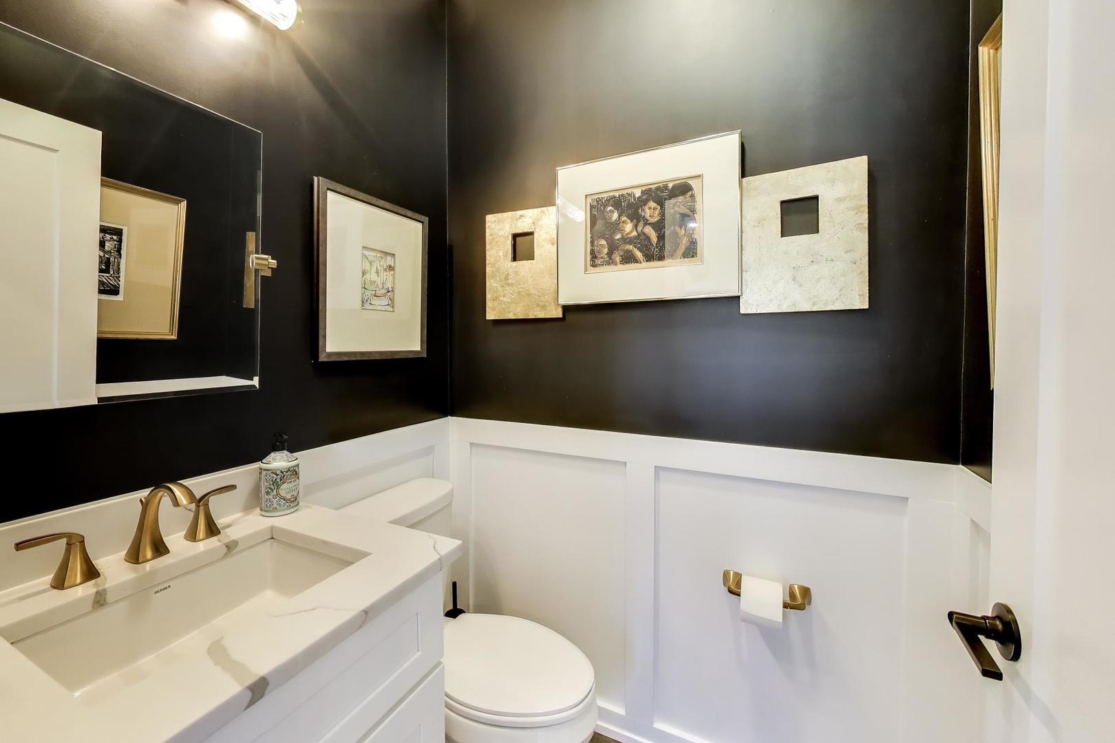 347 East 44th Street Chicago, IL 60653 - Photo 17 of 38 a bathroom with a sink vanity mirror and toilet