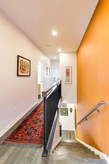 a view of entryway with furniture and wooden floor