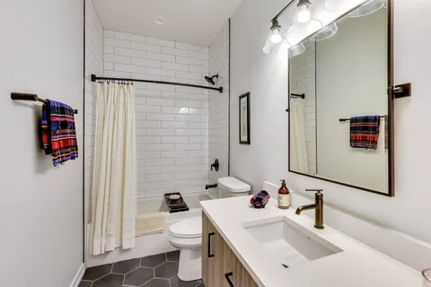 a bathroom with a sink toilet and shower