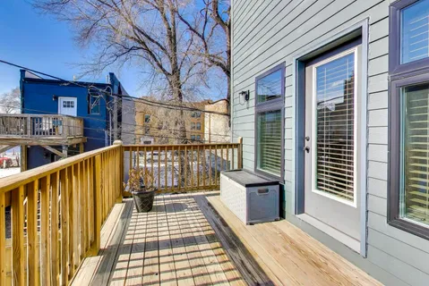 a view of a balcony with wooden floor and fence