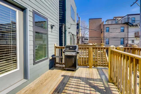a view of a balcony with wooden floor and fence