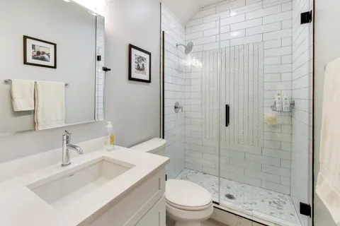 a bathroom with a sink toilet and shower